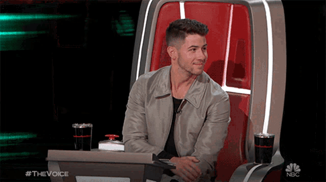 a man sits in a chair with a nbc logo on the bottom