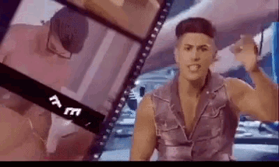 a man in a purple vest is standing in front of a film strip that says ' t.e. ' on it