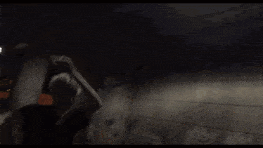 a man is laying on a rock in a river