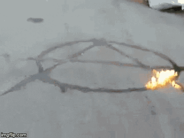 a gif of a fire burning in the middle of a road says imgflip.com