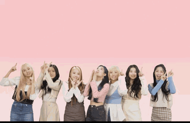 purple kiss on the bloody top written on a pink background with a group of girls standing next to each other