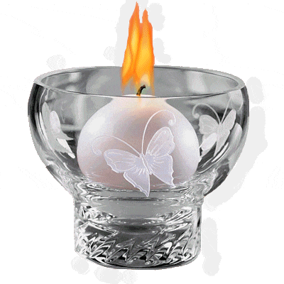 a candle with a butterfly on it in a glass