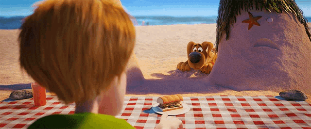 a cartoon character is looking at a sand sculpture