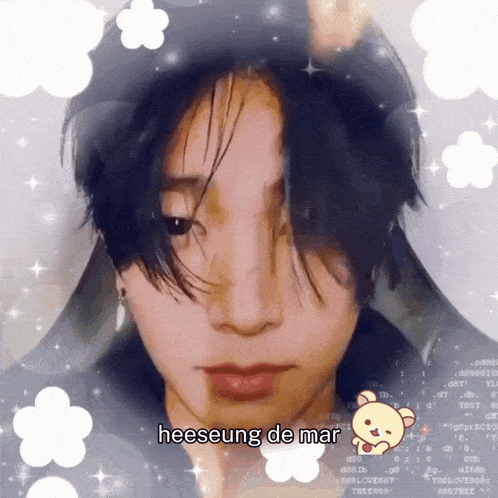 a close up of a person 's face with the words heeseung de mar written on it