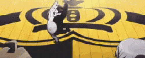 a black and white cat is jumping in the air in front of a yellow and black logo .