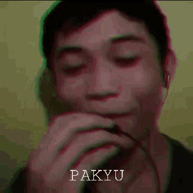 a close up of a man 's face with the name pakyu written on the bottom