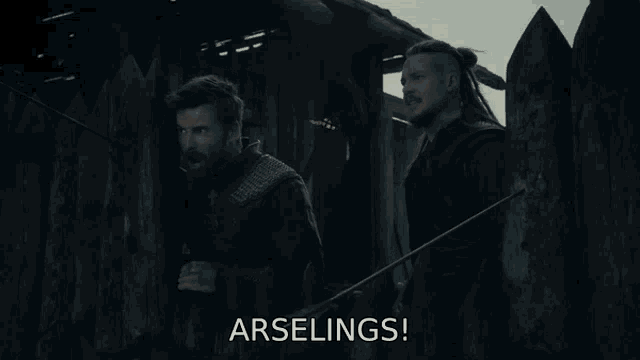 two men are standing next to each other and the word arselings is visible