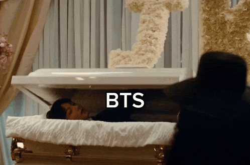 a man in a coffin with the word bts written on it