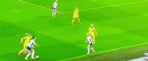 a group of soccer players are playing on a field and one player has the number 18 on his jersey