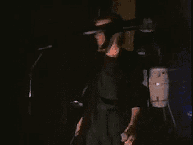 a man is playing a guitar and singing into a microphone