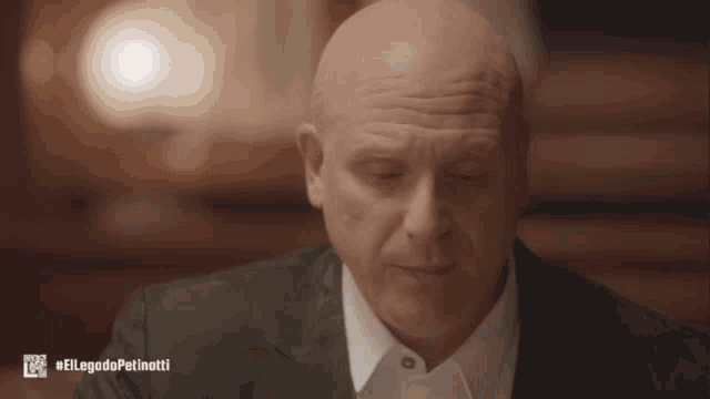 a bald man in a suit and white shirt with the hashtag #ellegadopatinotti