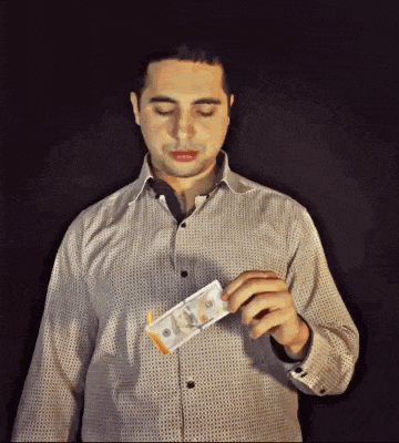 a man in a shirt is holding a stack of money in his hand