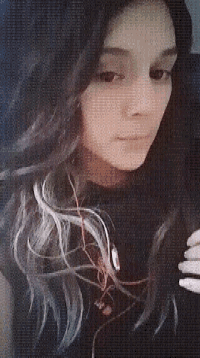 a close up of a woman 's face with a black shirt on