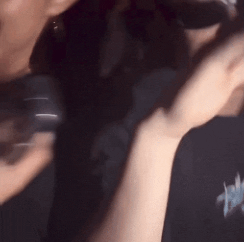 a close up of a person holding a microphone in their hand .