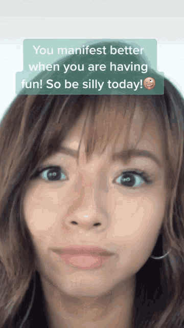 a woman 's face with a caption that says " you manifest better when you are having fun "