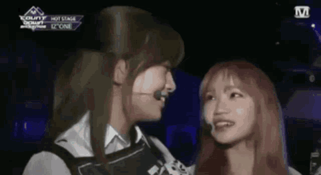 a couple of women are standing next to each other and smiling .