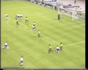 a soccer game is being played on a field with a few advertisements on the fence