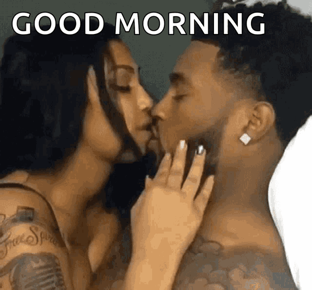a man and woman are kissing in bed with the words `` good morning '' above them .
