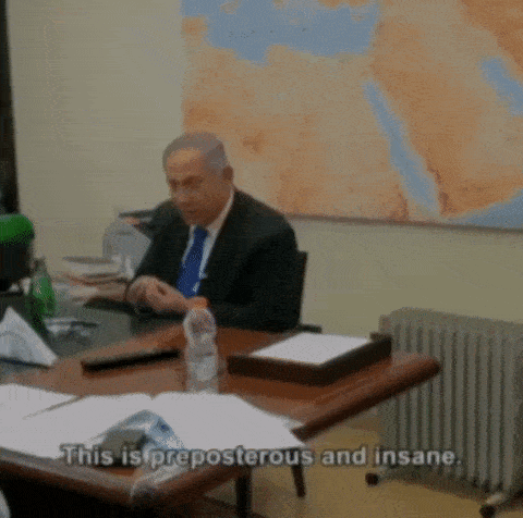 a man sits at a desk with the words " this is preposterous and insane " written on the table