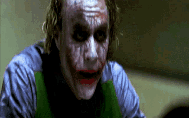 a close up of the joker 's face with blood on his face