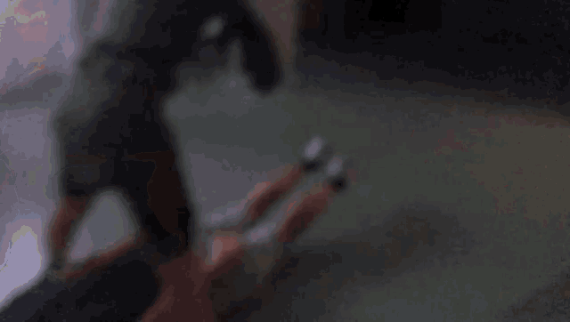 a blurry picture of a person laying on the ground with their legs crossed .