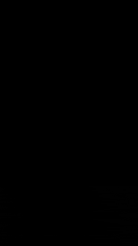 a round piece of metal with a hole in the middle on a dark background