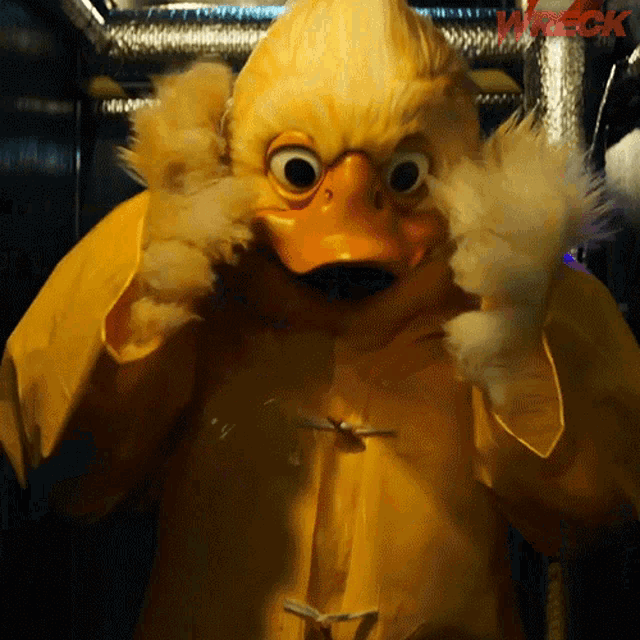a person in a yellow duck costume with the word wreck on the bottom right
