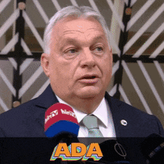 a man in a suit and tie is speaking into a microphone with the word ada written below him