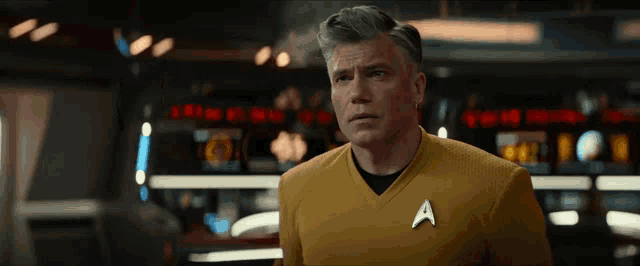 a man in a yellow shirt with an a on his chest