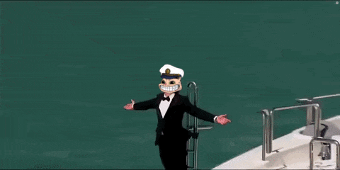 a man in a tuxedo and hat is standing on the side of a yacht .