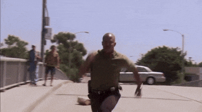 a man without a shirt is running down the street