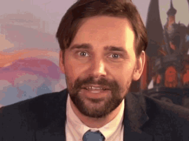 a man with a beard in a suit and tie