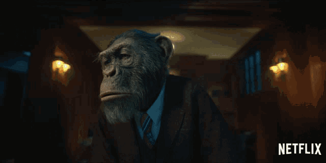 a picture of a chimpanzee in a suit and tie with the netflix logo behind him