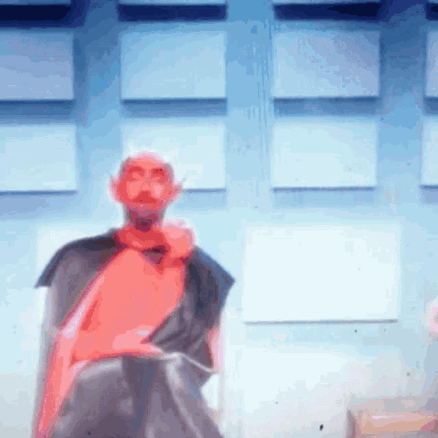 a blurry picture of a man with a red cape on