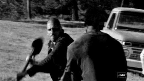 a black and white photo of two men standing next to each other in a field with a truck in the background .
