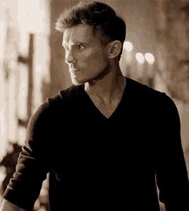 a man wearing a black shirt with a v neck