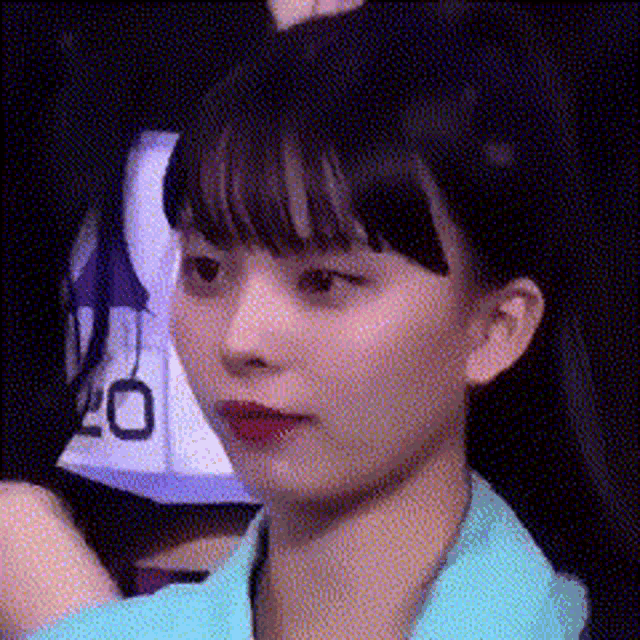 a close up of a girl 's face with a number 20 jersey behind her .