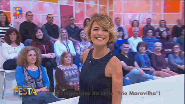 a woman stands in front of a crowd of people and the words festa are on the bottom