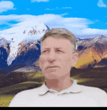 a man stands in front of a snowy mountain