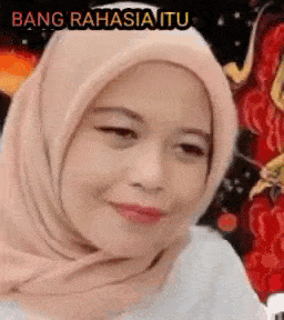 a close up of a woman wearing a hijab and smiling .