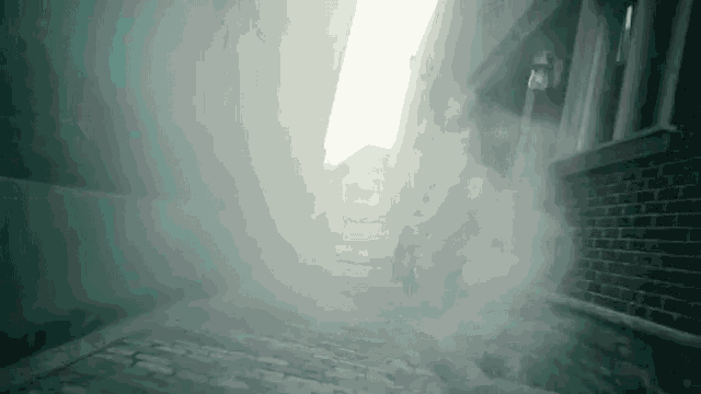 a person is walking down a cobblestone street in a foggy city .