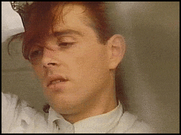 a man with red hair is wearing a white shirt and tie