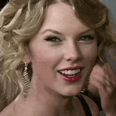 a close up of a woman 's face with blonde hair and red lips