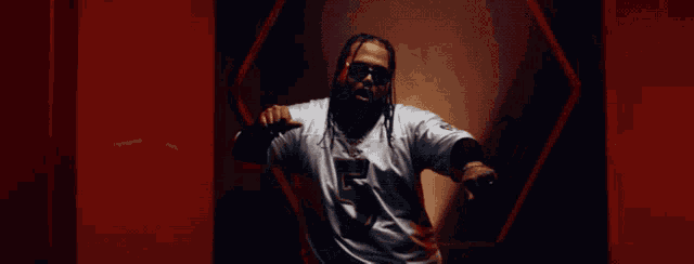 a man with dreadlocks wearing a number 5 jersey