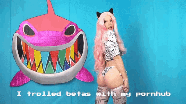 a woman in a pink wig stands in front of a pink shark with the words " i trolled betas with my pornhub "