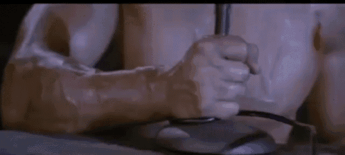 a close up of a person 's fist pressing a button on a mouse .