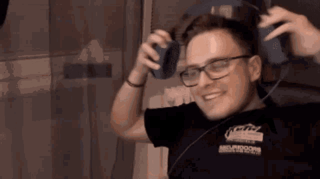a man wearing glasses and a t-shirt that says ' oculus ' on the front