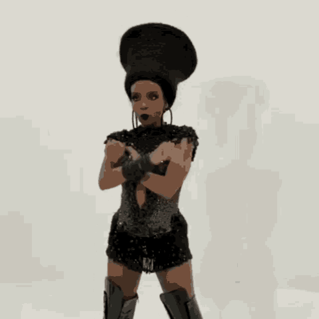 a statue of a woman in a black dress with a large afro on her head