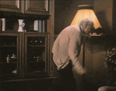 a man in a white shirt and tie is jumping in the air