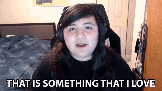 a woman wearing headphones is saying that is something that i love